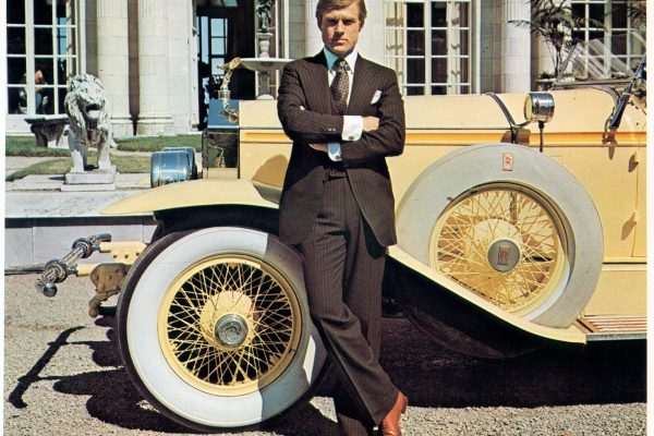 Robert Redford leaning against luxurious car in a scene from the film 'The Great Gatsby', 1974. (Photo by Paramount/Getty Images)